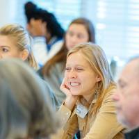 woman smiling at panelists